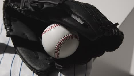 Handheld-Close-Up-Studio-Baseball-Still-Life-With-Ball-Catchers-Mitt-And-Team-Jersey-1
